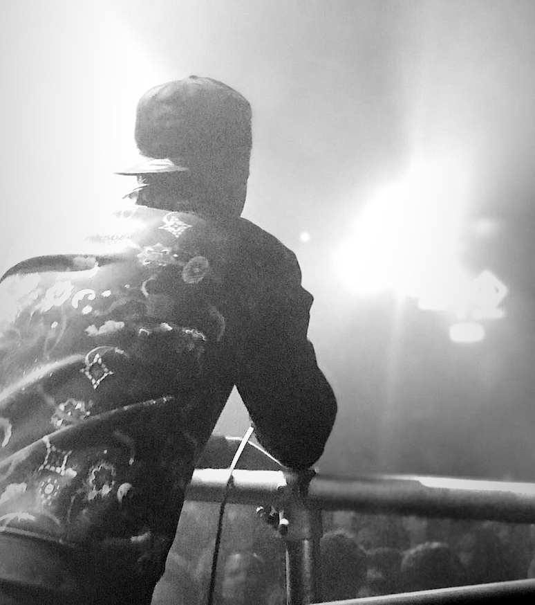 Live club appearance — silhouette on stage under the lights